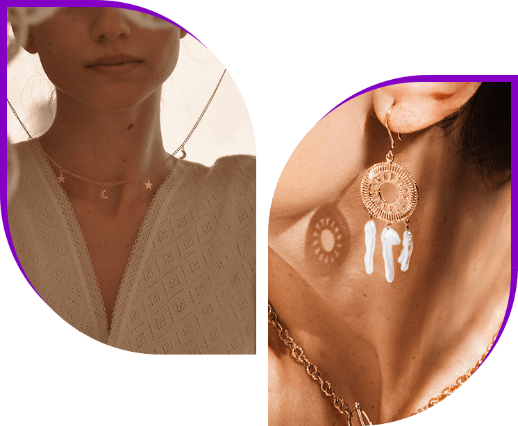 A woman wearing two different necklaces and one is holding her hand up to the side of her neck.