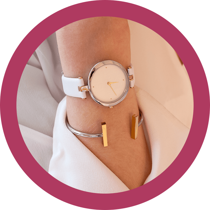 A woman wearing a white watch and bracelet.