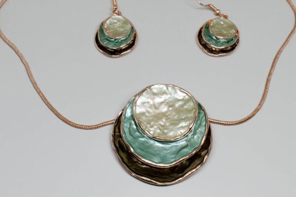 A necklace and earrings set with mother of pearl.