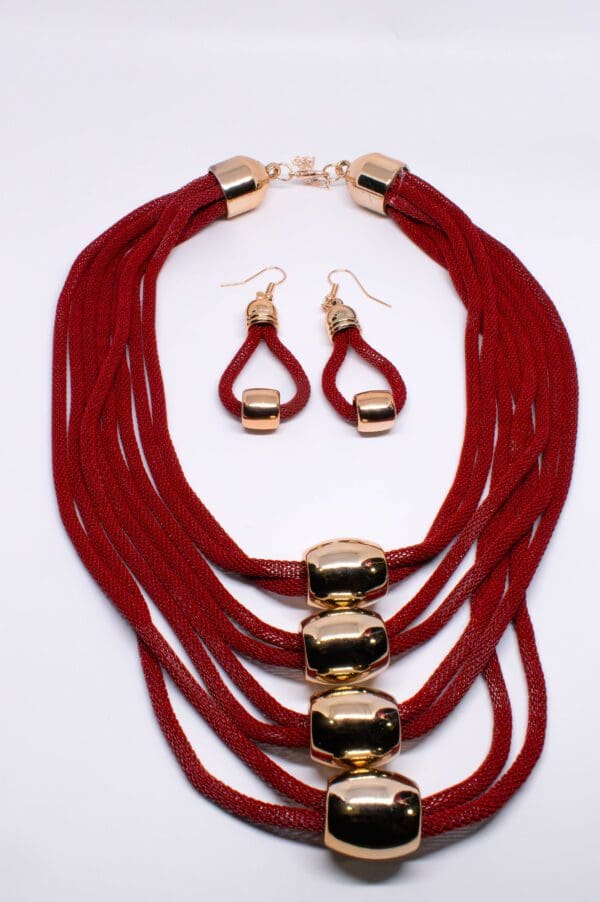 A necklace and earrings set with red cords.