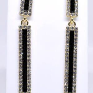 A pair of long earrings with black and clear stones.