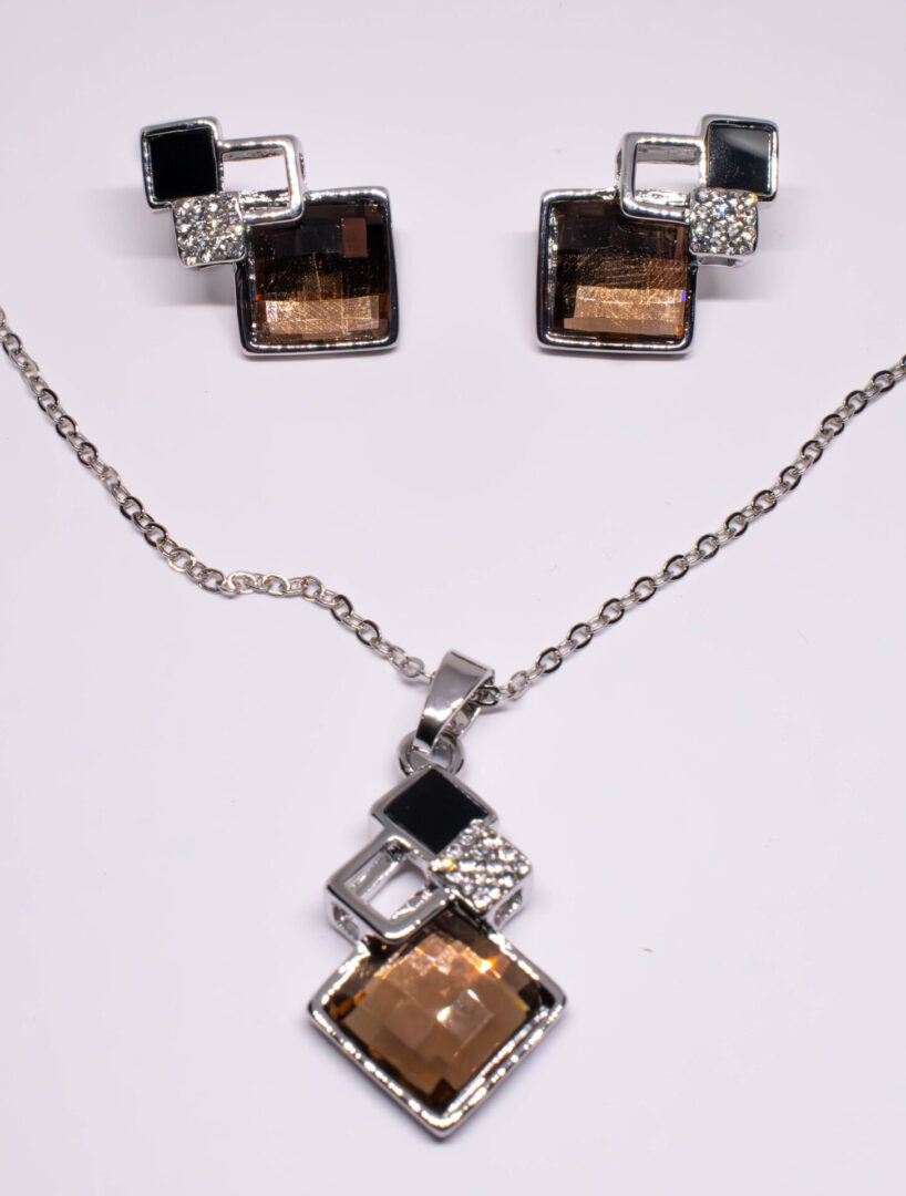 A necklace and earrings set with brown stones.