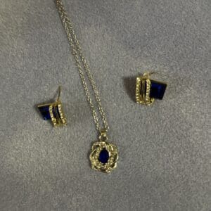 A necklace and earrings set with gold chains.