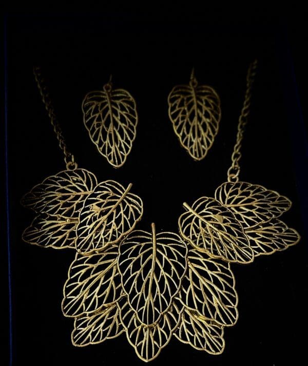 A necklace and earrings set with gold leaves.