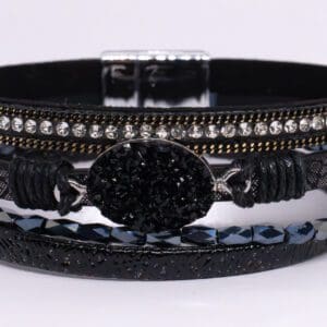 A black bracelet with some stones on it