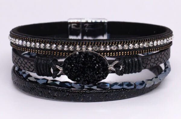 A black bracelet with some stones on it