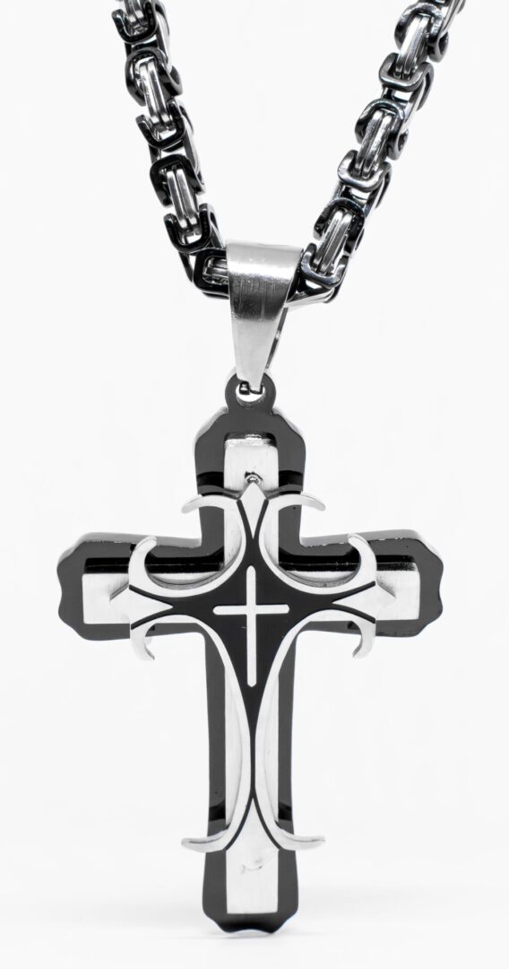 A cross with a chain hanging from it.