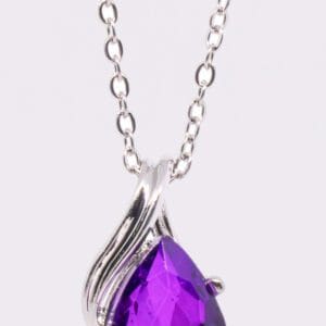 A purple necklace with a large stone on it