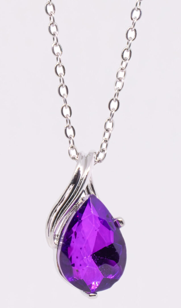 A purple necklace with a large stone on it