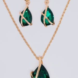 A necklace and earrings set with green stones.