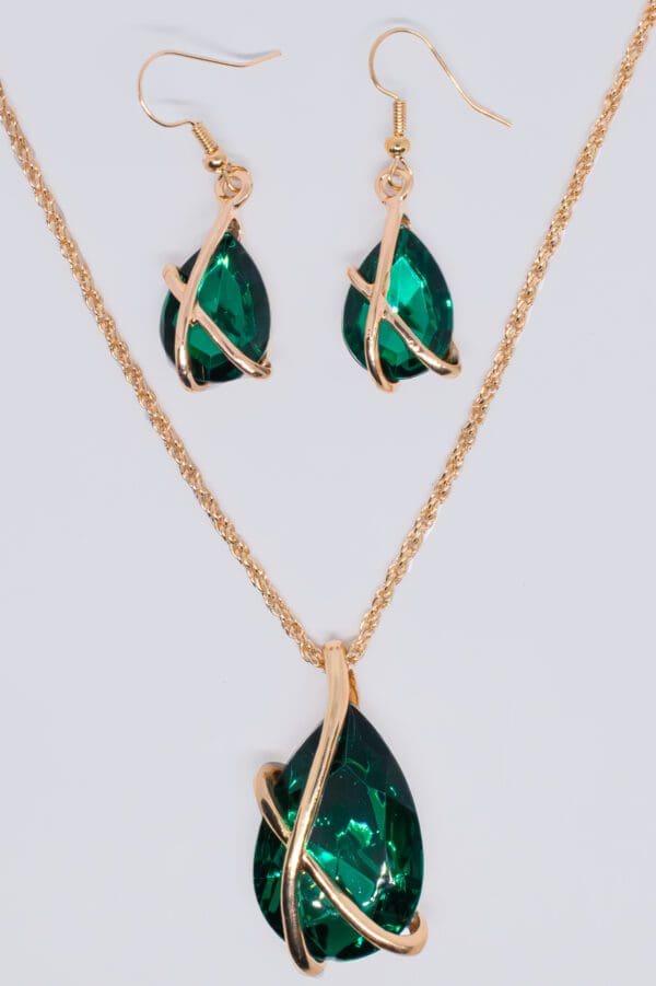 A necklace and earrings set with green stones.