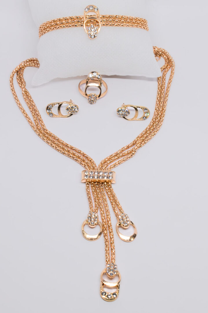 A necklace and earrings set with gold chain.