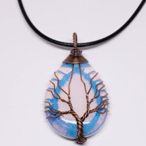 A blue and white tree of life necklace.