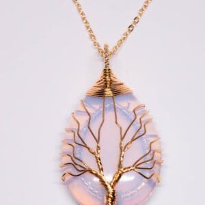 A tree of life necklace with a pink opal stone.