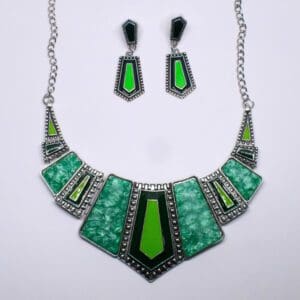 A necklace and earrings set with green stones.