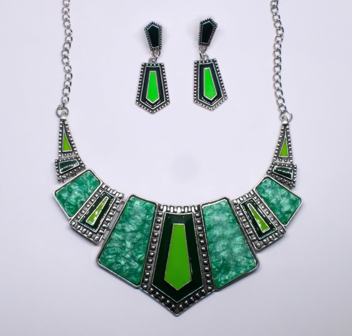 A necklace and earrings set with green stones.